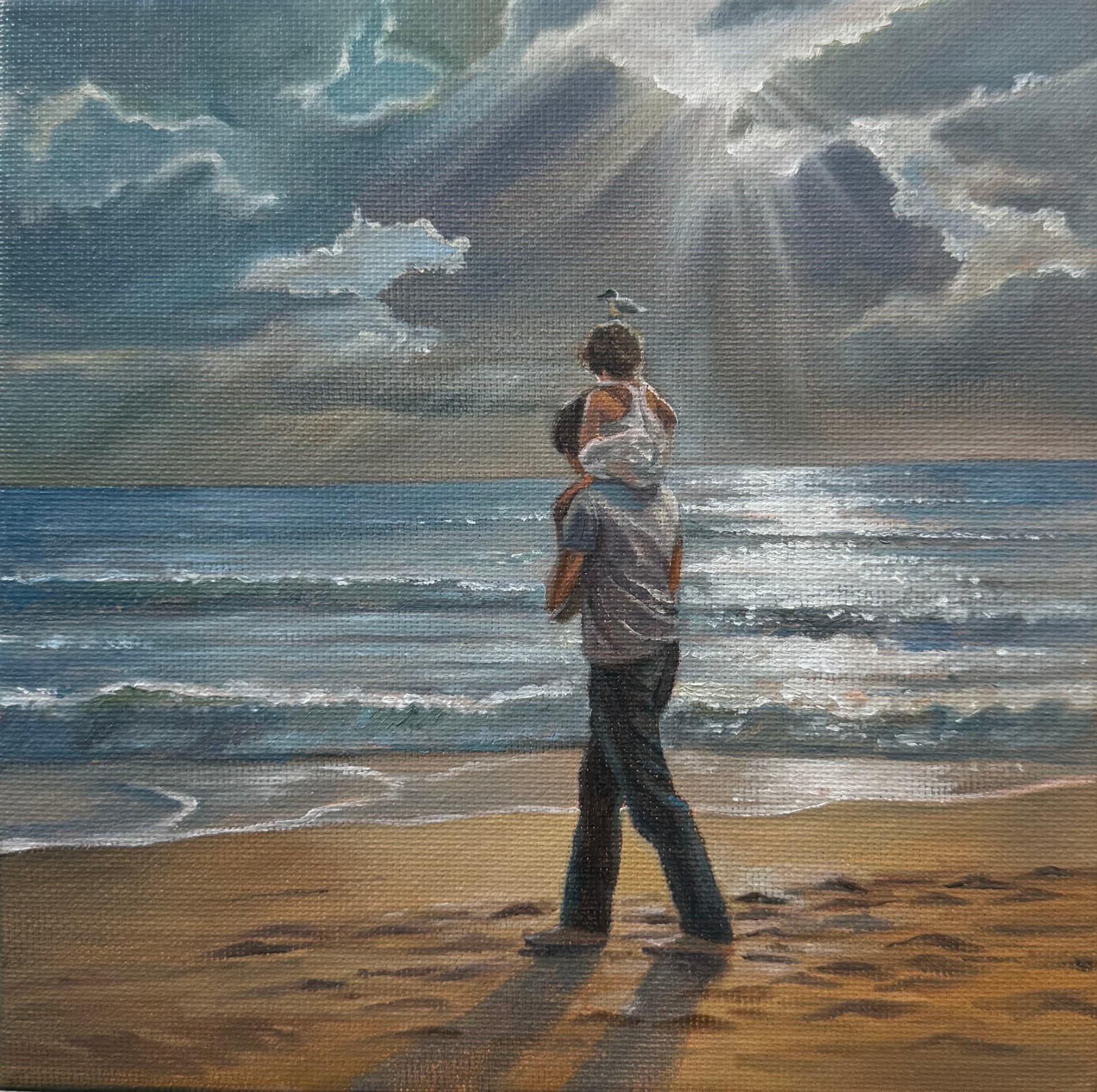 A child riding on an adult's shoulders, facing the sea